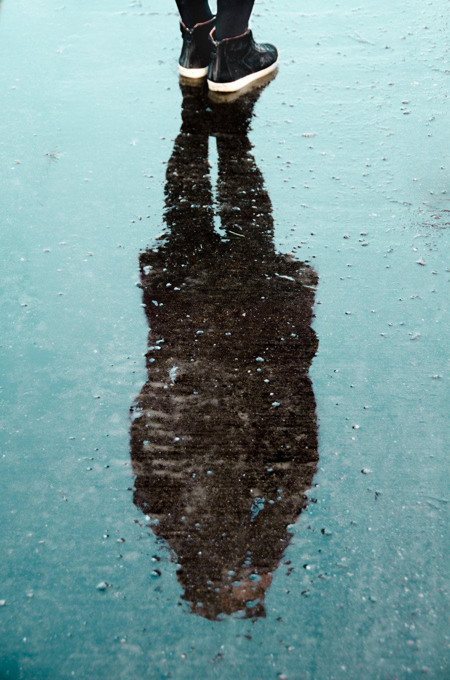 Woman reflected on water by Peter Heeling